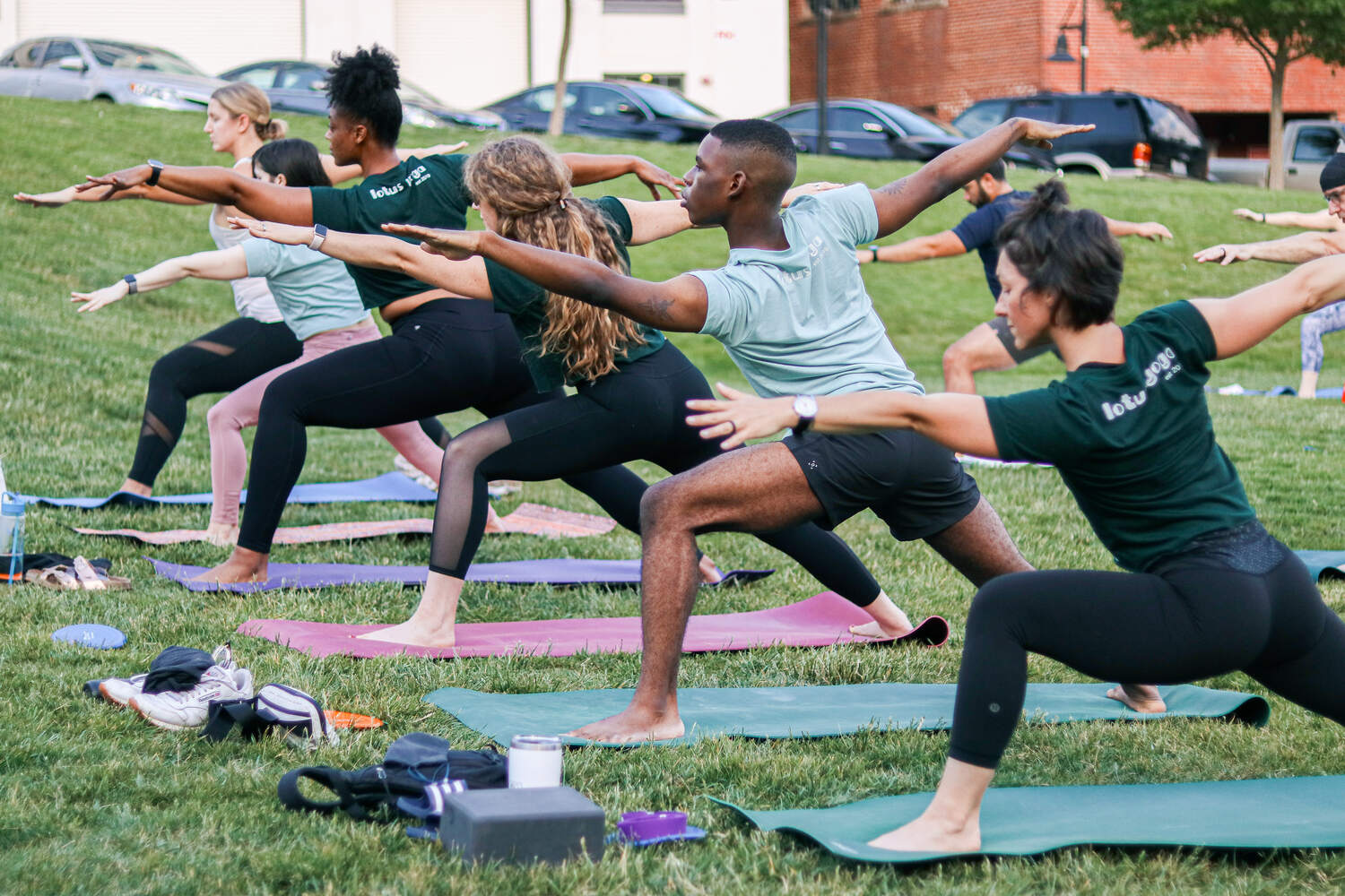 People practice yoga at Bailey Park during Sunset Salutations event.