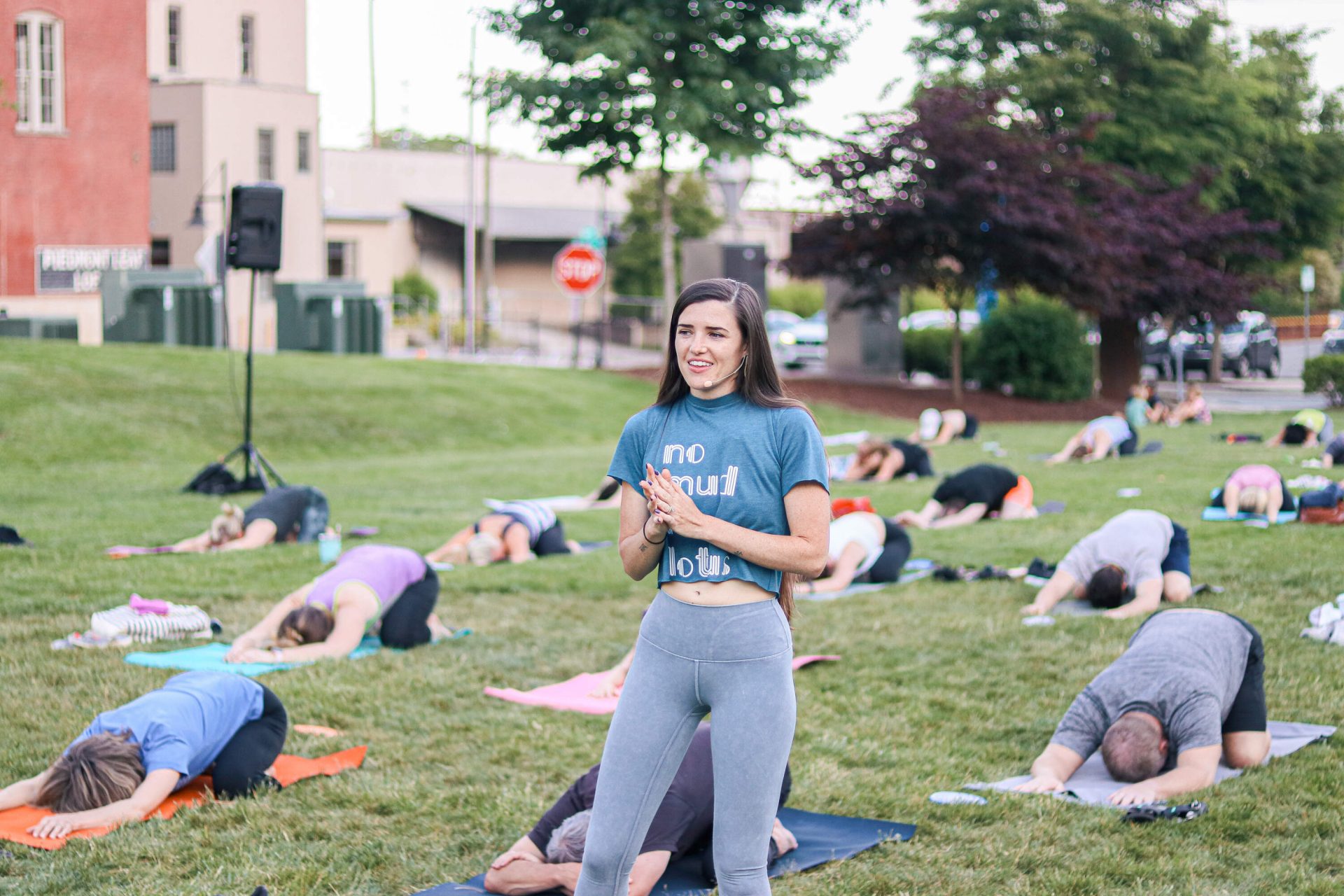 Chloe Craver teaches yoga at Sunset Salutations community event.