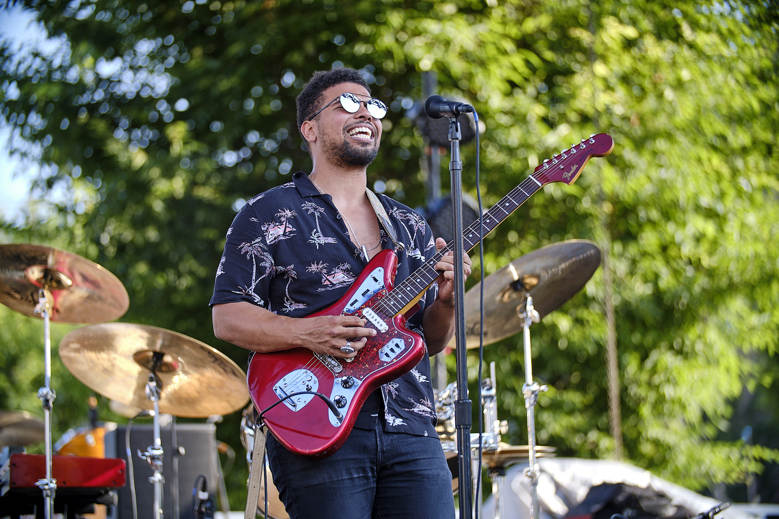 Devon Gilfillian, holding a guitar, performs at the 2019 Gears & Guitars Festival.