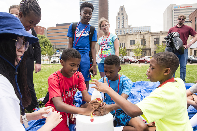 A diverse group of children attending a science and technology program in Bailey Park, one of the Innovation Quarter's placemaking efforts.
