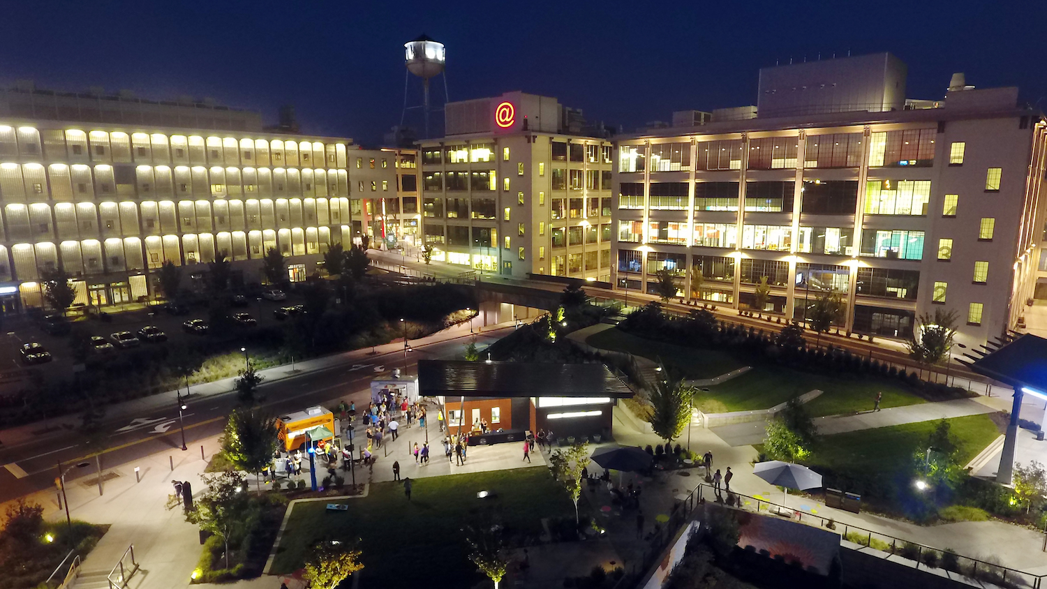 Food trucks line up at Bailey Park at night in the Innovation Quarter.